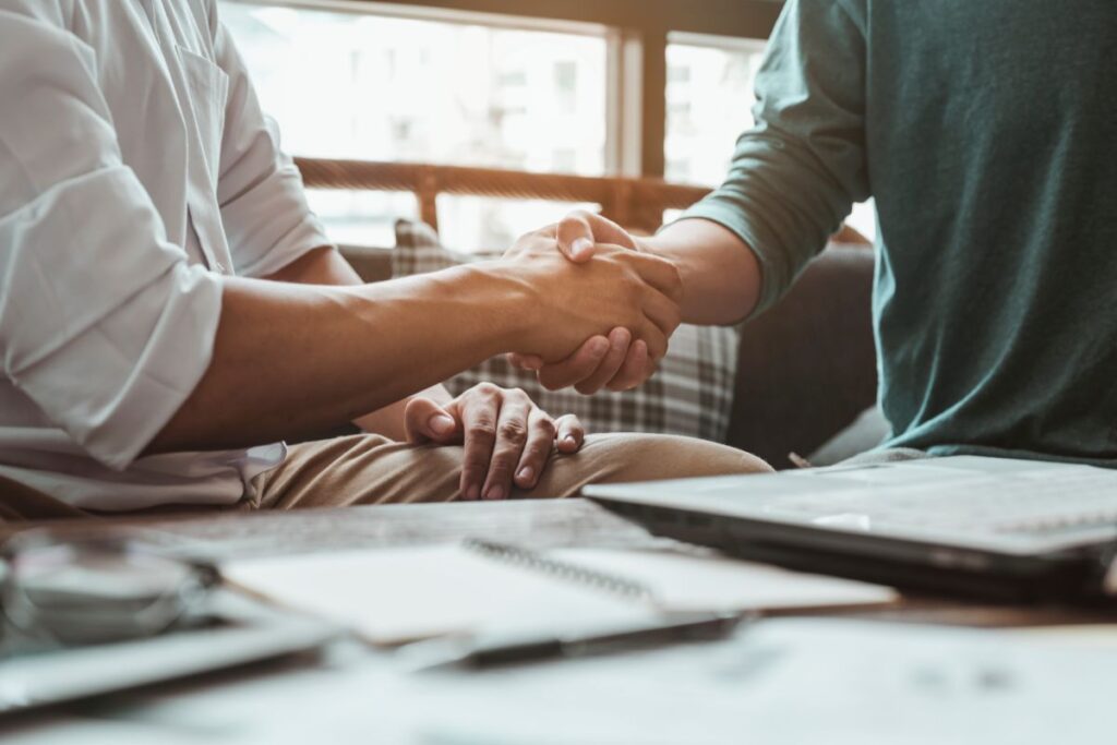 Handshake, meeting, greeting, teamwork, business, congratulate concepts. Commander handshaking new employee congratulating with starting a new job. Teamwork collaboration concept for business partners.